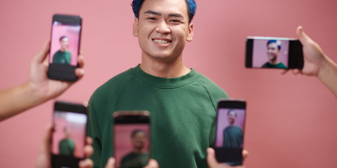 Portrait,Of,Happy,Blogger,Enjoying,Being,Photographed,By,Subscribers